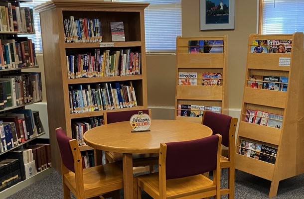 Table for Seating With Books On Shelves
